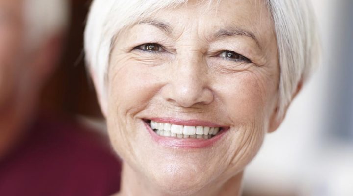 Senior woman dental patient with beautiful smile thanks to Dr. Keith Silverman
